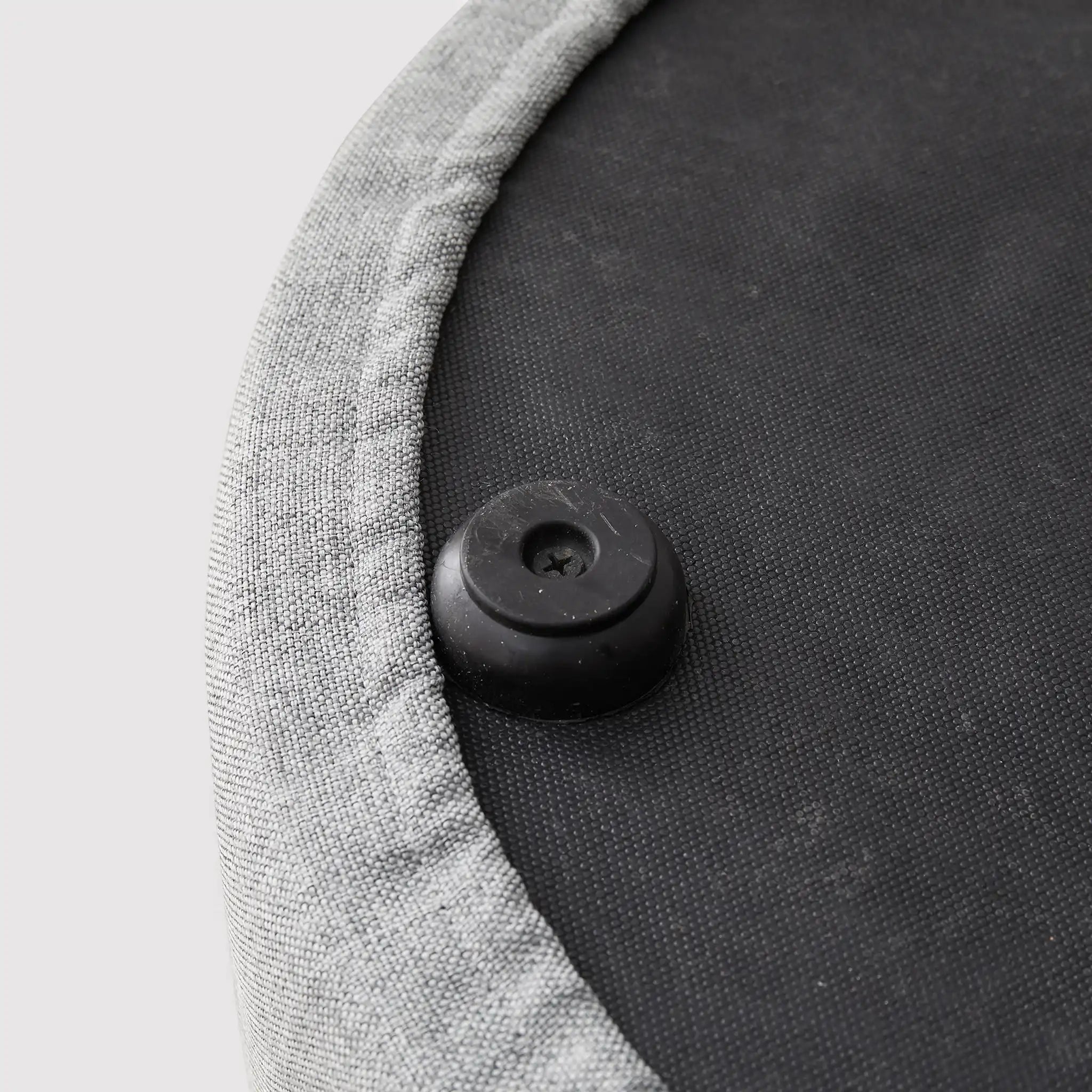 Round gray footrest ottoman in padded fabric