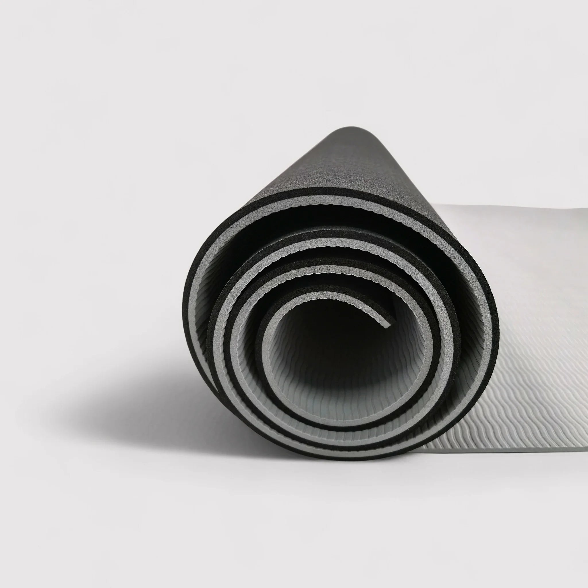 Non-slip black and gray yoga mat for home or outdoor use