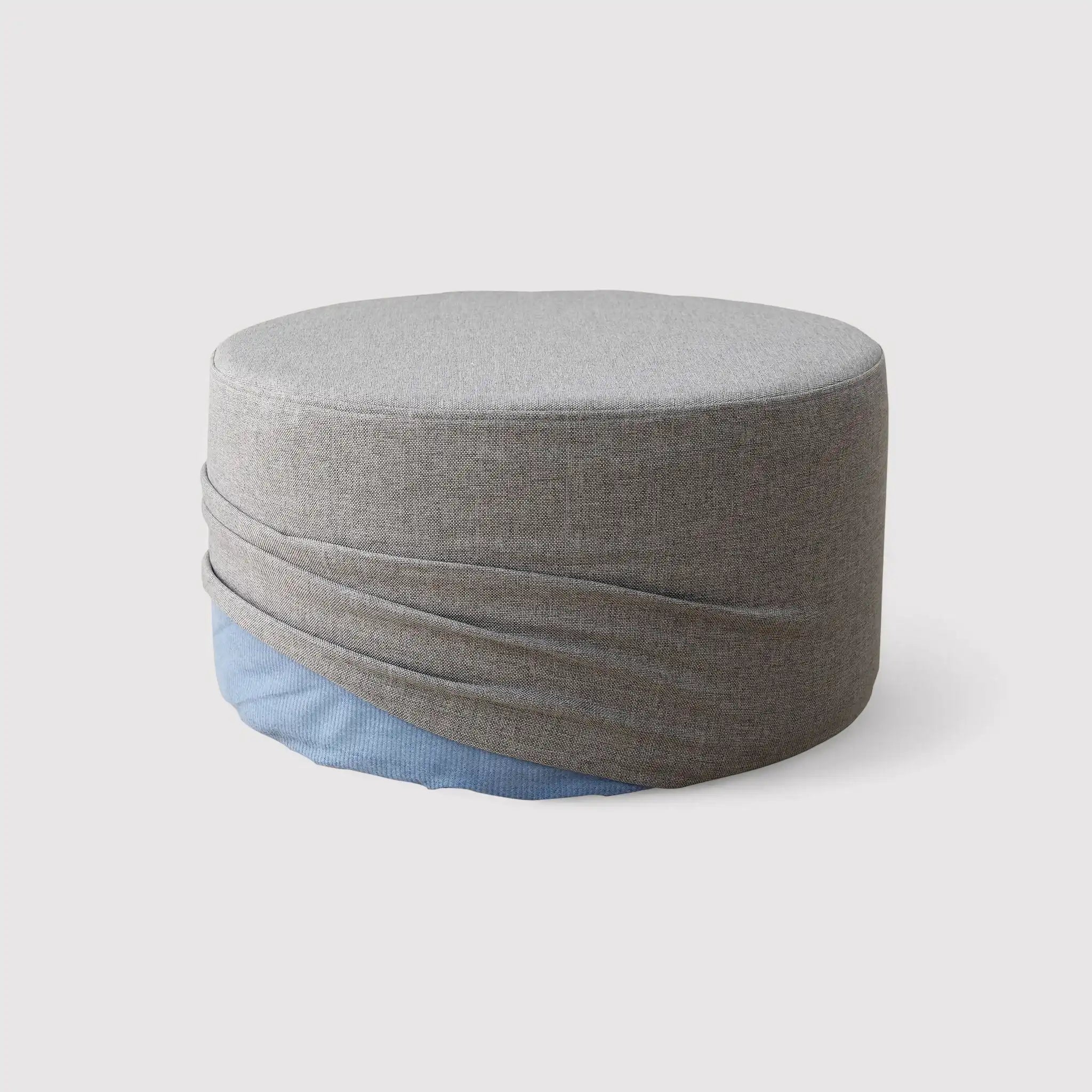Round gray footrest ottoman in padded fabric